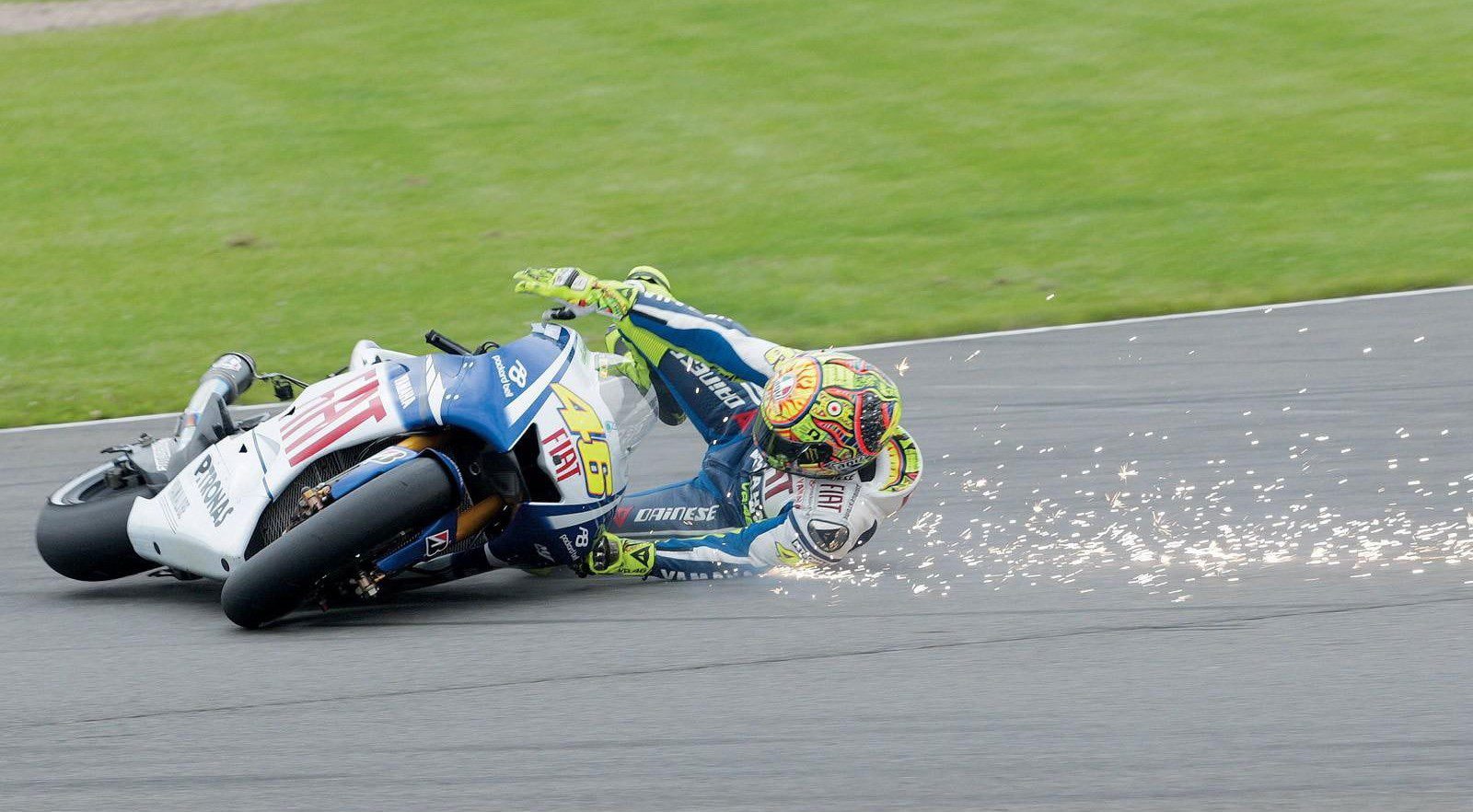 Men crashing from bike while wearing leather motorbike suit