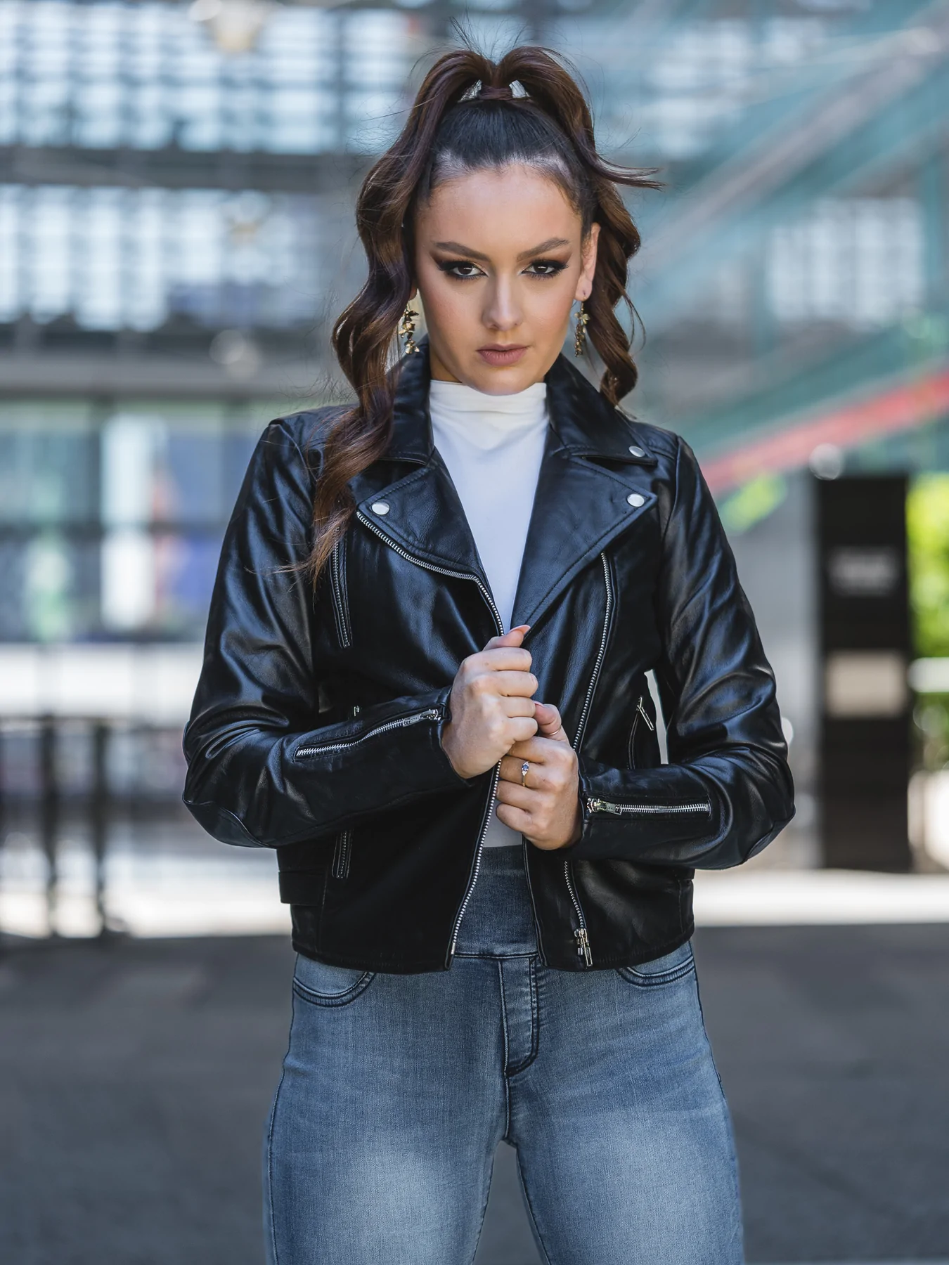 Woman waring the iconic classic moto leather motorcycle jacket