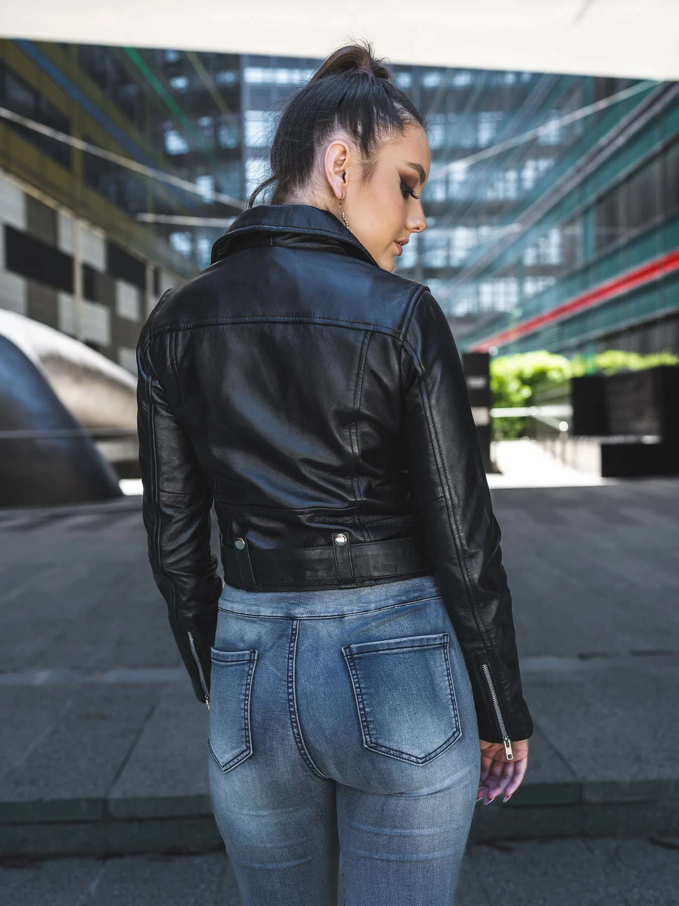 Back side presence of cropped belted leather jacket